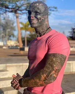 A MAN has transformed himself into a 'black alien'