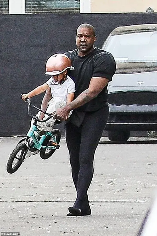 Kanye West plays with son Psalm, 4… while ‘wife’ Bianca is hidden beneath a bizarre black dress