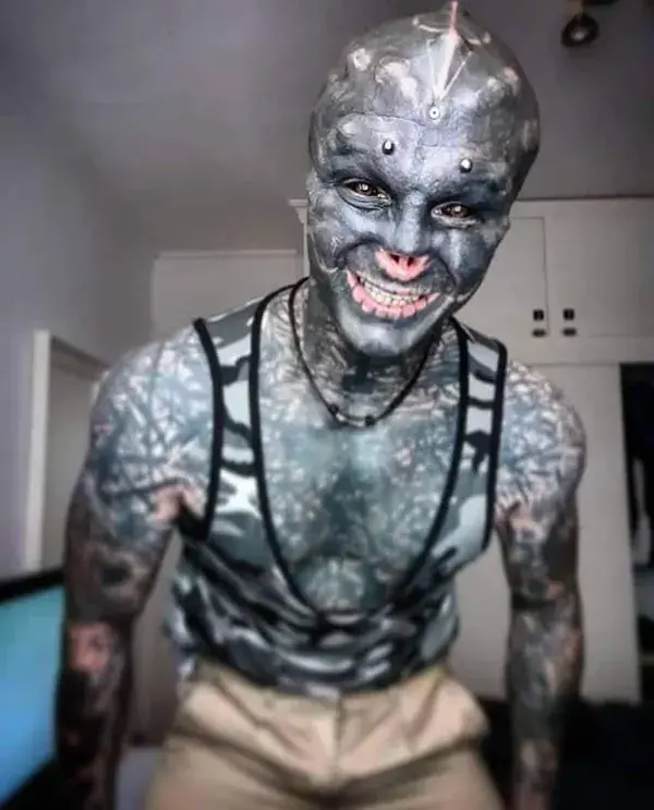 A MAN has transformed himself into a 'black alien'