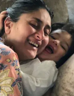 Taimur cuddles with mommy kareena.