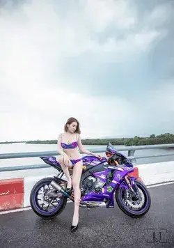 Purple colour bike with girl in purple bra and penty