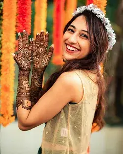 Happy Indian bride at mehndi function.