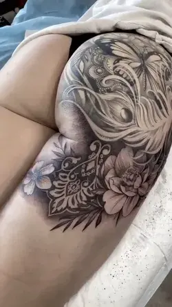 Booty tattoo inspiration for women - woman gets a piece added to her booty tattoo