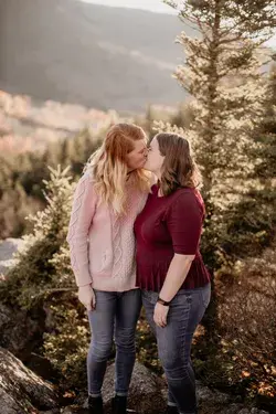 Sunny mountaintop engagement session after board game proposal