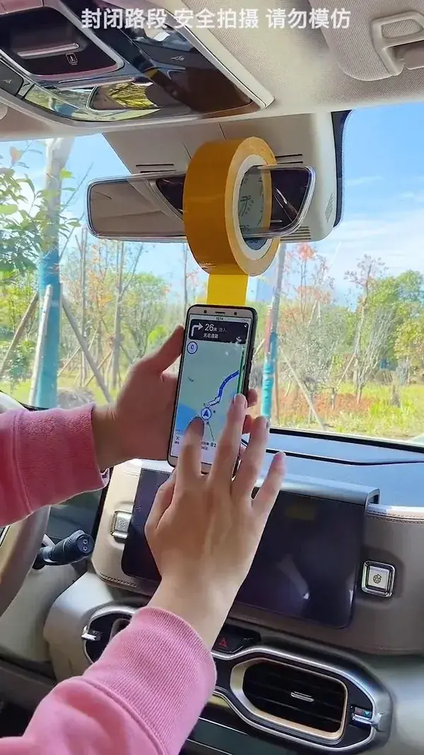 Rearview mirror phone holder