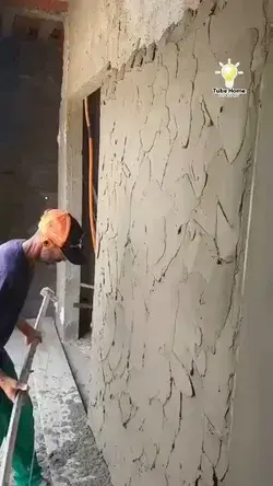 worker shaping plaster on wall - tube home