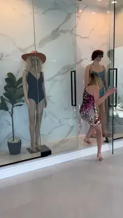 Woman hide herself in mannequin display area
