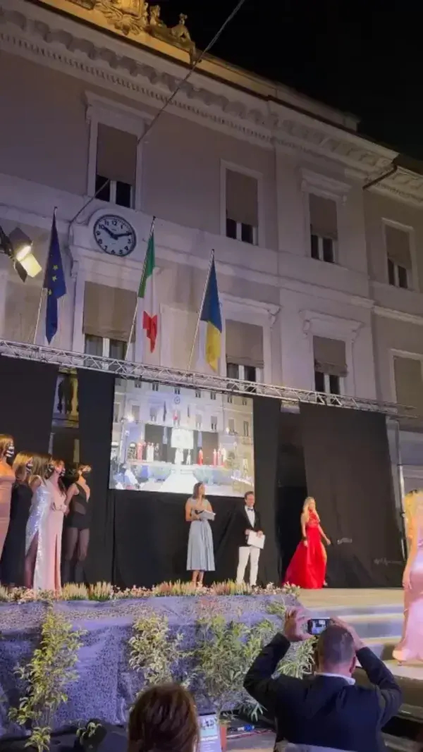 Miss Italia in red dress and golden shoes