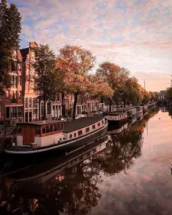 Mesmerizing palette of Netherlands' canal houses reflecting their elegance on tranquil waterways!🏠✨