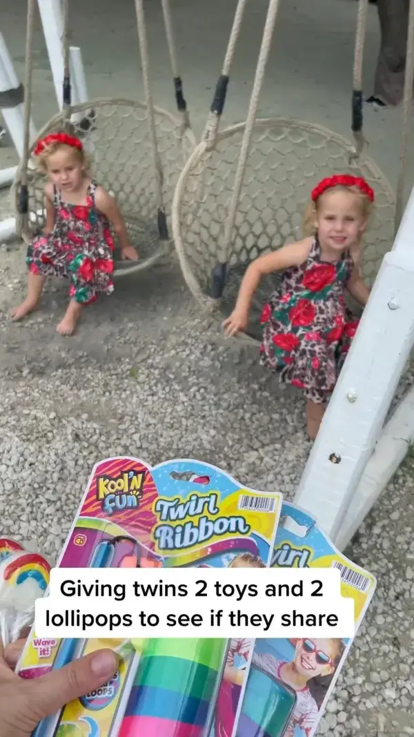 Twin sisters sharing toys. So cute!